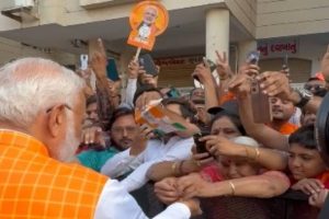 Woman ties rakhi to PM Modi as huge crowd gathers outside polling booth in Ahmedabad